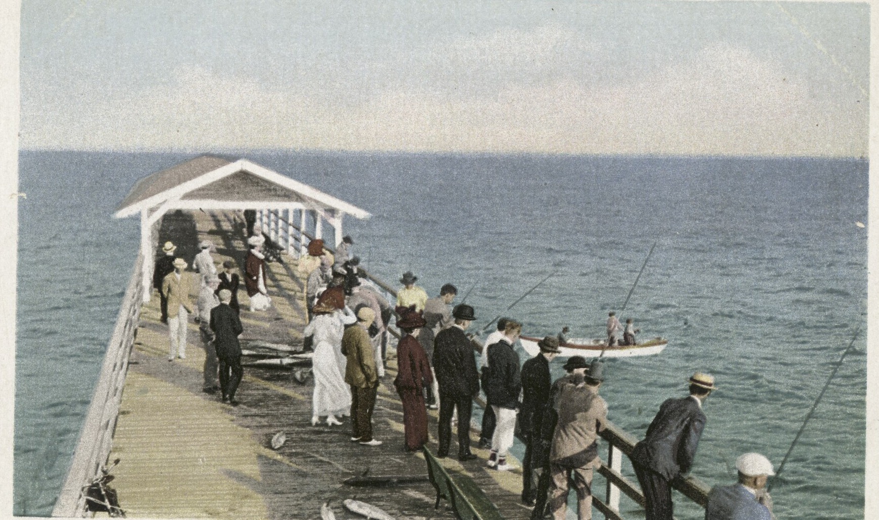 The old Palm Beach fishing pier around 1910, crowded with people in period dress, a place long gone.
